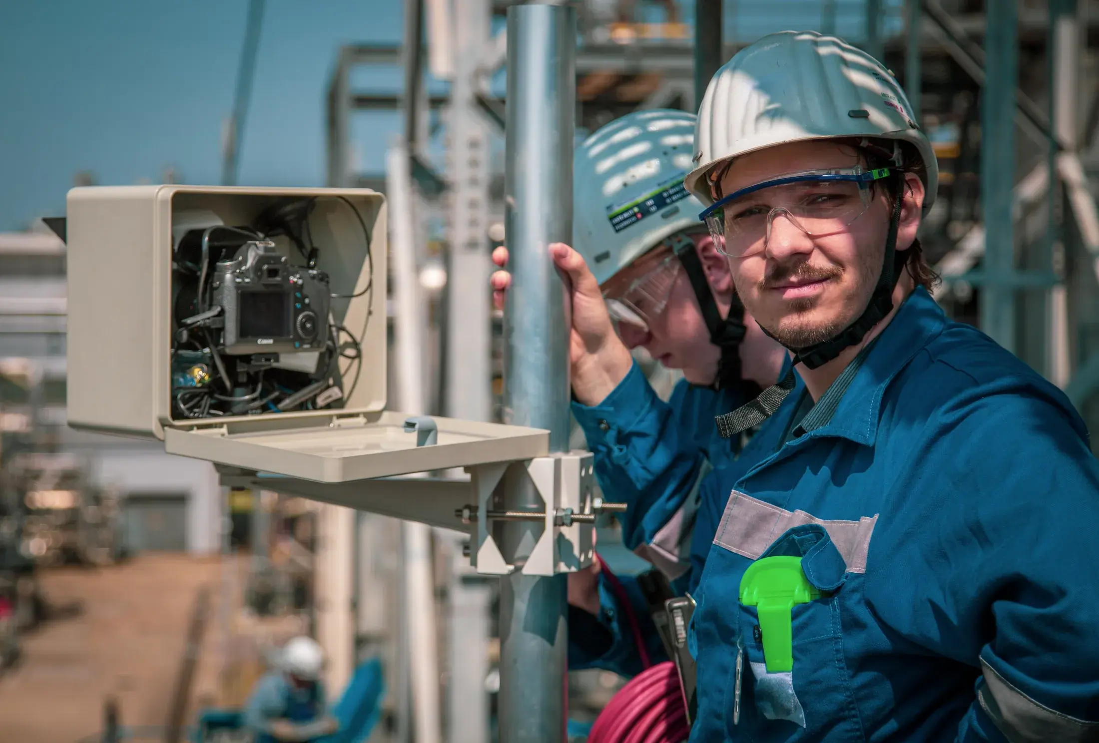 Technicians installing a construction camera